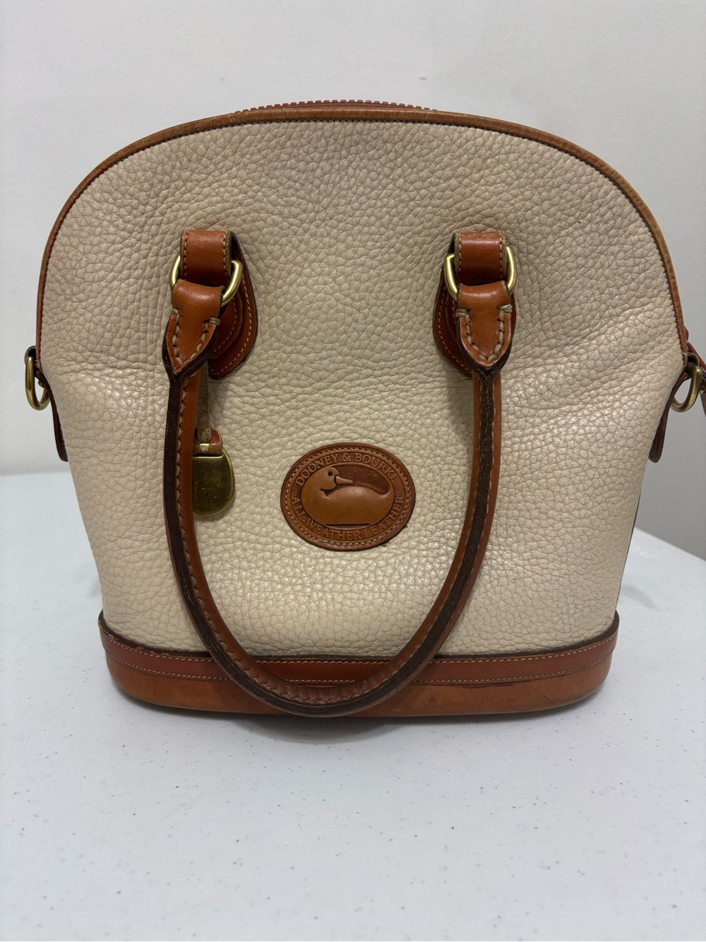 Dooney & Bourke Cream Pebbled Leather Satchel with Brown Trim and Brass Hardware